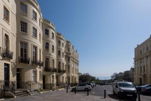 ulica z samochodami zaparkowanymi przed budynkami w obiekcie Sea View Penthouse Maisonette by MyHolidayLet w Brighton and Hove