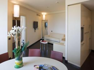 une chambre avec une table et des chaises ainsi qu'un salon dans l'établissement Grand Hotel Mattei, à Ravenne