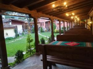 a porch with benches and a view of a yard at Once upon a time in Koprivshtitsa