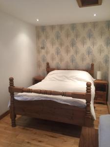 una camera con letto e struttura in legno di The Old Vicarage Lodge a Manchester