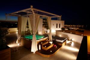 a backyard with a swimming pool at night at Relais Valle Dell'Idro in Otranto