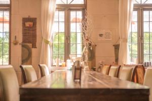 a dining room with a table and chairs and windows at Nikko Park Lodge Mountain Side in Nikko