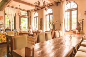 a dining room with a wooden table and chairs at Nikko Park Lodge Mountain Side in Nikko