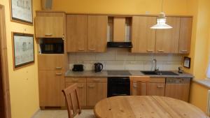 a kitchen with wooden cabinets and a wooden table at Ferienwohnung Freiberg, Chemnitzer Straße in Freiberg