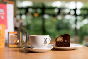 a cup of coffee and a piece of cake on a table at YHA Bristol in Bristol