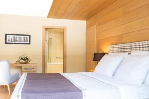 a bedroom with a bed and a desk and a chair at Korona, Resort & Entertainment in Kranjska Gora