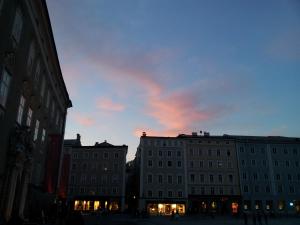 a view of two buildings in a city at dusk at Haus Wartenberg in Salzburg