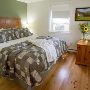 A bed or beds in a room at Farmhouse Inn B&B