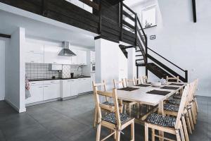 uma cozinha e sala de jantar com uma mesa de madeira e cadeiras em Pradnik Valley Lodge em Prądnik Korzkiewski