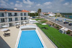 an overhead view of a swimming pool next to a building at Cerca da Vitoria 3 Milfontes in Vila Nova de Milfontes