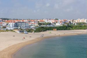 a group of people on a beach near the water at Cerca da Vitoria 3 Milfontes in Vila Nova de Milfontes