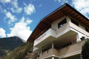 a hotel with the mountains in the background at Birkenheim Widmann in Längenfeld