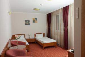 Postel nebo postele na pokoji v ubytování Hotel Hermes