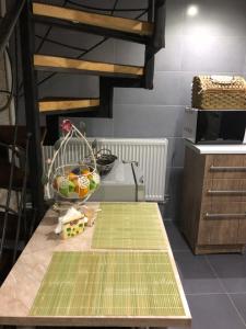 a kitchen with a table with a basket of fruit on it at Apartment Lui in Tbilisi City