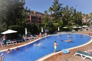 a group of people swimming in a swimming pool at Aparthotel SunClub Salou in Salou