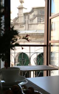 a view of a building from a window with a table at Apartamentos Plaza Mayor in Gijón