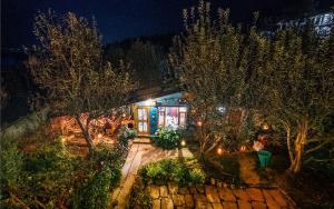 an aerial view of a house at night with lights at Orchards House - The Hidden Tribe in Manāli