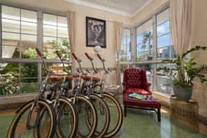 a row of bikes parked in a room with a chair at Century Hotel in Miami Beach