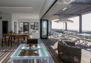 a living room with a table and chairs and a patio at Ocean Vista Boutique Guest House in Durban