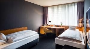 Una cama o camas en una habitación de Best Western Hotel Kaiserslautern