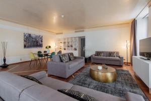 a living room with two couches and a table at Milan Royal Suites - Centro in Milan