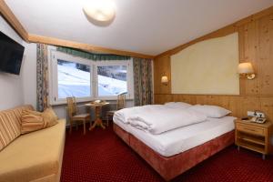 a hotel room with a bed and a window at Gasthof Burkert in Oetz