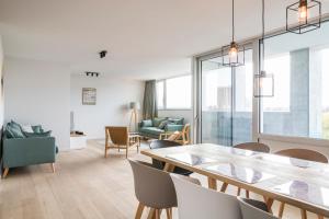 a dining room with a table and chairs at Skyline Flats Gent in Ghent