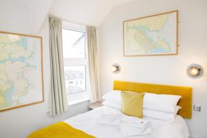 a bedroom with a bed and a map on the wall at The Lerryn in Falmouth