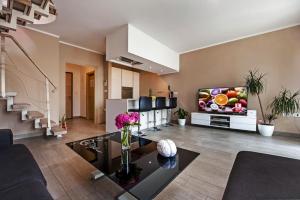 a living room with a flat screen tv on a wall at Apartments Babo in Rovinj