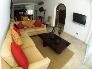 a living room with a couch and a table at Mondavi in Puerto Vallarta