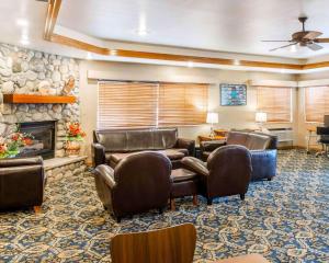 a waiting room with leather chairs and a fireplace at Comfort Inn Salida in Salida