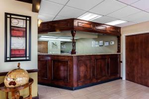 a lobby with a large wooden bar in a building at Quality Inn & Suites Mooresville-Lake Norman in Mooresville