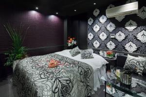 a bedroom with a large bed with flowers on it at Restay Okayama (Adult Only) in Okayama