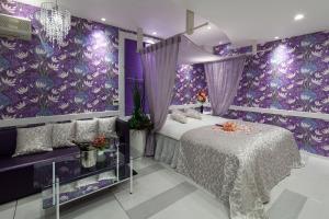 a purple bedroom with a bed and a purple wall at Restay Okayama (Adult Only) in Okayama