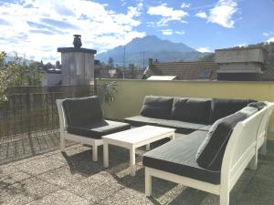 a patio with two chairs and a couch and a table at Modern & Central Apartments in Luzern