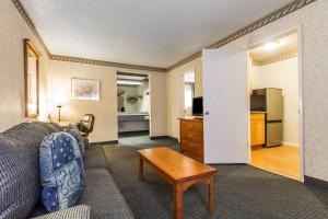 a living room with a couch and a table in a room at Quality Inn & Suites Silicon Valley in Santa Clara