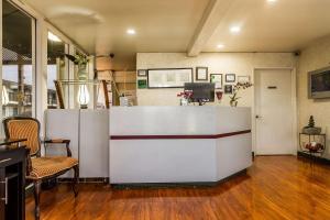 a lobby with a white counter and chairs in a room at Quality Inn & Suites Silicon Valley in Santa Clara