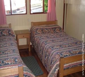 מיטה או מיטות בחדר ב-Hostal Emalafquen