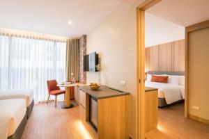 Säng eller sängar i ett rum på The Key Premier Hotel Sukhumvit Bangkok