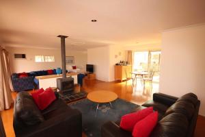 a living room with a couch and a fireplace at Verona Vineyard Cottage in Pokolbin