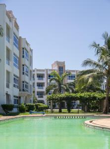 a large pool in front of some buildings at Almasi Oceanfront Nyali in Mombasa