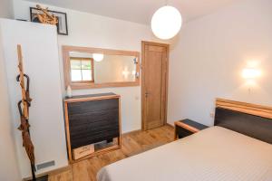 a bedroom with a bed and a window and a mirror at Apartamentai Geliu Vila in Nida