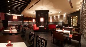 a restaurant with tables and chairs in a room at Vivanta Coimbatore in Coimbatore