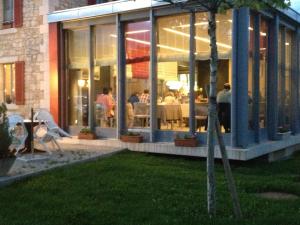 a restaurant with people sitting inside of a building at Au Boeuf Rouge in Crassier