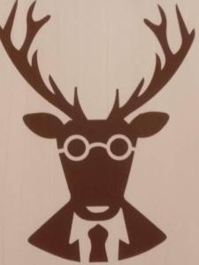 a reindeer wearing glasses and a tie at Chez Alphonse in Thônes