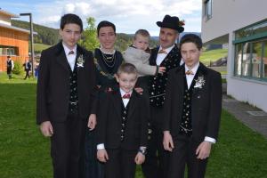 a group of young men in tuxedos posing for a picture at Kompatscherhof in Castelrotto