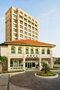 a hotel with a large building in the background at The Majestic Malacca Hotel - Small Luxury Hotels of the World in Melaka