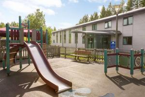 une aire de jeux avec toboggan en face d'un bâtiment dans l'établissement Days Inn Winchester, à Winchester