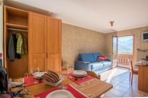 a living room with a table and a blue couch at Residence Fior d'Alpe in Bormio