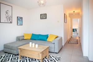 a living room with a couch and a coffee table at Résidence 3 etoiles Les thèmes Proche Lux, Metz, Cattenom in Hayange